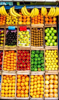 an assortment of fruits and vegetables displayed in crates