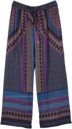 These straight-leg pants are fashioned from soft, flowing rayon, featuring a distinctive print with geometric and tribal patterns in shades of blue, purple, and brown. The design is both eye-catching and stylish, perfect for adding a bohemian flair to any wardrobe. #tlb #SplitSkirtsPants #bohemianfashion Boho Whimsical, Purple And Brown, Bohemian Pants, Blue Clothing, Boho Clothes, Hippie Look, Trendy Skirts, Split Skirt, Rayon Pants