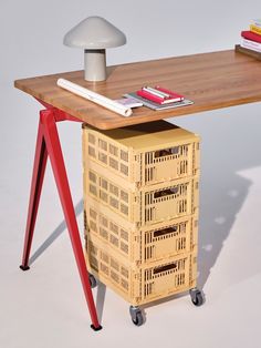 a wooden table topped with drawers and a lamp