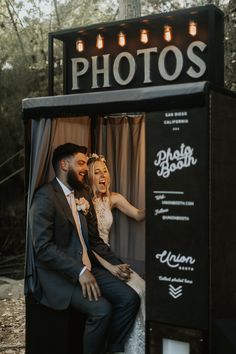 a bride and groom sitting in a photo booth with the words photos written on it