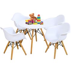 a white table with four chairs and a teddy bear