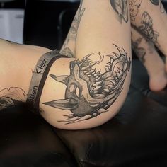 a woman's leg with tattoos on it and a tattoo design on the side