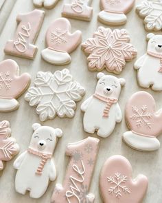 cookies decorated with frosting and decorations on a table top, including teddy bears, snowflakes and hearts