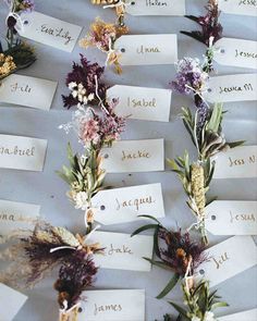 flowers are arranged on top of each other with name tags attached to the backs of them