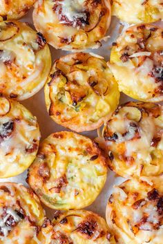 mini quiches with melted cheese and vegetables in them