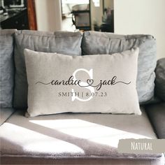 a gray couch with a white pillow on it and the words candice & jack