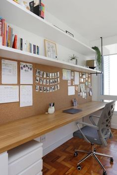 an office with a desk, chair and bookshelf filled with papers on the wall