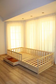 a wooden bed frame in front of a window