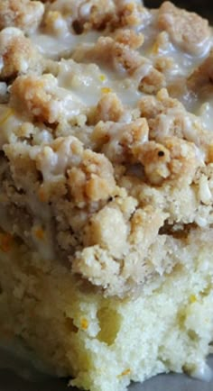 a close up of a piece of cake on a plate with icing and crumbs