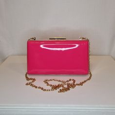 Womens fuschia pink patent evening clutch bag with gold embellishment and top closing clasp (please note: bag is full all over patent finish and any patterns are only reflections) Can be used with or without long shoulder chain (included) size approx- H 10.5cm x W 18.5cm Optional Dust Bag: White lightweight soft polyester portable travel dust bag pouch, suitable for protecting items from dust, dirt, hairs and scratches when not in use size approx- L 47cm x W 31.5cm Material: 100% polyester Pleas Pink Chic Evening Bag For Formal Occasions, Glamorous Pink Bags For Formal Occasions, Pink Rectangular Evening Clutch, Chic Pink Clutch For Formal Occasions, Elegant Pink Rectangular Clutch, Pink Rectangular Clutch For Events, Party Glossy Finish Rectangular Bag, Rectangular Glossy Finish Party Bag, Pink Evening Bag With Gold-tone Hardware