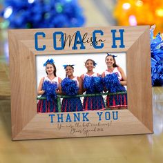 a wooden frame with blue cheerleaders and the words coach thank you on it