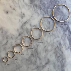 Our favorite classic everyday hoops! A bold look yet lightweight and comfortable so they won't weigh down your ears. From jeans and t-shirt to a LBD, these earrings are a staple this season. Tube Thickness 2mm. Also available in 3mm and 4mm thickness.  15mm (0.60") Diameter 20mm (0.80") Diameter 25mm (1.00") Diameter 3 20mm Gold Hoop Earrings, Modern Gold Hoop Earrings With Gold-tone Hardware, Nickel-free Yellow Gold Plated Hoop Earrings, Hypoallergenic 14k Gold-filled Hoop Earrings, Hypoallergenic Adjustable 14k Gold-filled Hoop Earrings, Gold Piece, Earring Sale, Gold Hoops, Gorgeous Jewelry