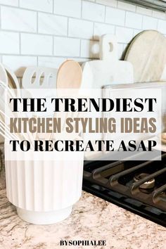 a white cup sitting on top of a counter next to an oven with the words, the trendist kitchen styling ideas to create asap