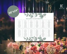 wedding seating chart displayed on table with flowers and chandelier in the back ground