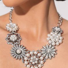 Polished White Pearls And Brilliant White Rhinestones Bloom Atop A Framework Of Silver, Forming Seven Unique Flowers Adorned In Dizzying Detail. Each Flower Features A Unique Centerpiece Encircled By Silver Petals Lined With Luminescence And Intricate Detail. The Flourish Of Florals Links Whimsically Along The Neckline, Resulting In An Unforgettable Statement Piece That Sparkles With Sentiment. Features An Adjustable Clasp Closure. Sold As One Individual Necklace. Includes One Pair Of Matching E Pearl Rhinestone Necklace For Party, Party Pearl Rhinestone Necklace, Elegant Embellished Silver Jewelry, Formal Pearl Embellished Jewelry, Formal Embellished Pearl Jewelry, Beaded Rhinestone Necklace For Formal Occasions, Evening Pearl Jewelry Embellished, Evening Embellished Pearl Jewelry, Glamorous Embellished Formal Necklace