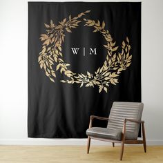 a black and gold wall hanging next to a chair