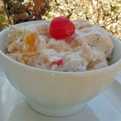 a white bowl filled with food on top of a table