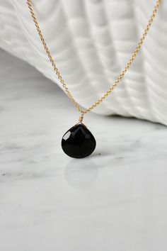 This black onyx hangs from a dainty chain in 14k gold filled, rose gold or sterling silver. Subtle and simple, this beautiful semi-precious onyx necklace is the perfect everyday necklace and great for layering.  The black onyx (approx. 11mm) is facetted and has a discrete shine.  Made using the highest quality USA and UK sourced materials. All stones are selected individually. Natural variations in size, color, cut and clarity are typical and add to the unique artisan craftsmanship of this neckl Black Faceted Jewelry As A Gift, Black Faceted Jewelry For Gift, Elegant Black Drop Necklace Gift, Elegant Black Teardrop Pendant Drop Necklace, Elegant Black Teardrop Drop Necklace, Elegant Black Briolette Jewelry, Elegant Onyx Teardrop Necklaces, Teardrop Onyx Gemstone Jewelry, Elegant Onyx Teardrop Necklace