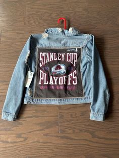 Custom NHL Colorado Avalanche 2021 - 2022 Stanley Cup Championship distressed denim jacket. Jacket is a normal fit small. One of a kind hand sewn! Letter Print Denim Jacket For Streetwear In Winter, Denim Blue Letter Print Outerwear For Streetwear, Denim Blue Outerwear With Letter Print For Streetwear, Winter Casual Denim Jacket With Letter Print, Casual Winter Denim Jacket With Letter Print, Casual Denim Jacket With Letter Print For Winter, Sporty Denim Outerwear For Streetwear, Medium Wash Long Sleeve Outerwear With Graphic Print, Urban Denim Jacket With Graphic Print For Winter