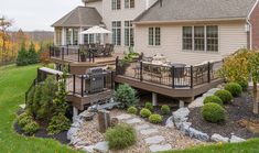 a house with a deck and patio in the front yard