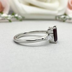 This beautiful ring is made from genuine 925 sterling silver with rhodium plating. Ring details- -The Main stone is an Emerald Cut 8mm by 6mm Lab Created Alexandrite Stone -Side stones are 4mm by 2mm Tapered Baguette simulated diamonds -Ring is casted in solid 925 sterling silver with rhodium plating (rose gold and yellow gold plated also available, please check the drop down menu for more options) -The Total face height of the ring measures 8mms and the band width measures 1.6mms -Each ring is Wedding Emerald Ring In 14k White Gold, Silver Wedding Cluster Ring With Baguette Cut, Silver Baguette Cut Cluster Ring For Wedding, Silver Princess Cut Emerald Ring For Wedding, Silver Baguette Cut Wedding Ring, Fine Jewelry Silver Baguette Cut Wedding Ring, Silver-toned Emerald Platinum Ring With Polished Finish, Silver Baguette Cut Fine Jewelry Wedding Ring, Silver Princess Cut Birthstone Ring With Gemstone