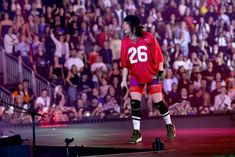 a man standing on top of a stage in front of a crowd