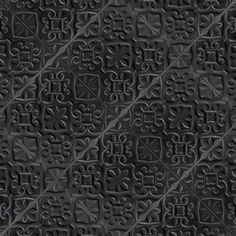 the texture of black leather with decorative designs on it, as well as an abstract pattern