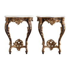 a pair of antique side tables with marble top and gold leaf decoration on the legs