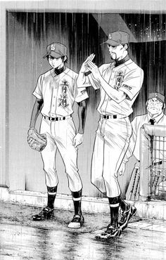 two baseball players are standing in the rain