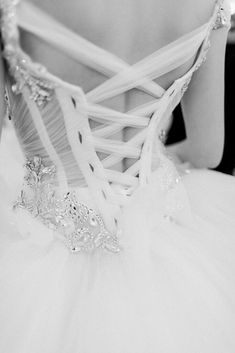 black and white photograph of a woman wearing a wedding dress with beading on it