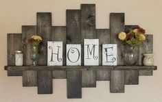 a wooden shelf with some vases on top of it and two signs that say home