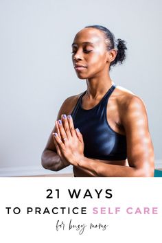 a woman sitting in a yoga position with her hands together