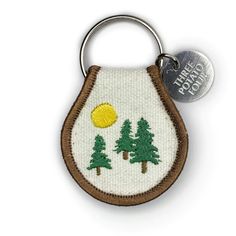 an embroidered key chain with trees on it