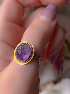 An extremely early Vintage scarab conversion ring with a sensual pink/orchid undertone to the sensual violet color of the stone. Once half of a pair of cufflinks, now a ring, this outstanding conversion has been fitted on a casting of a Victorian striped band. This particular ring is in excellent condition and is perfect for stacking or solo wear with a sizeable stone of 15mm. The ring is a delight to wear and would make a notable addition to any collection. Marks: 14k Age/Origin: Victorian scar Luxury Amethyst Cabochon Ring For Formal Occasions, Luxury Formal Cabochon Amethyst Ring, Luxury Formal Amethyst Cabochon Ring, Luxury Round Cabochon Amethyst Ring, Formal Fine Jewelry Signet Ring With Cabochon, Formal Cabochon Signet Ring, Formal Cabochon Amethyst Ring Fine Jewelry, Luxury Yellow Gold Amethyst Ring Oval Cabochon, Formal Heirloom Amethyst Cabochon Ring