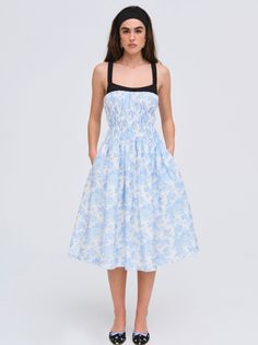 Crafted in 100% cotton poplin, the Oliver blue midi dress features a ruched elasticated bodice and gathered skirt for a flattering silhouette. Rendered in a charming rose print, this mid length dress has a contrast poplin neckline that's finished with a small satin bow at the center-front. Cotton Midi Dress With Ruched Bodice, Cotton Dress With Ruched Bodice For Daywear, Spring Cotton Smocked Dress With Ruched Detail, Spring Cotton Smocked Ruched Dress, Spring Cotton Midi Dress With Gathered Neckline, Spring Smocked Dress With Gathered Neckline And Fitted Bodice, Daywear Smocked Dress With Ruched Fitted Bodice, Smocked Midi Dress With Ruched Fitted Bodice, Knee-length Cotton Dress With Smocked Bodice