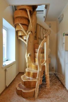 a spiral staircase made out of wooden logs