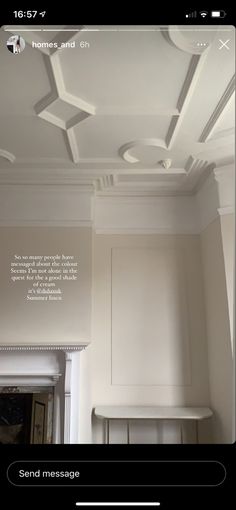 a room with white walls and ceiling tiles on the ceiling, there is a message written below