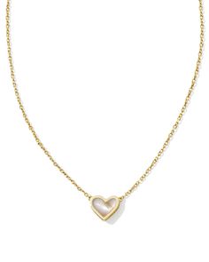 The bestseller you know and love, now in a flirty new design! The Framed Ari Heart Gold Short Pendant Necklace in Iridescent Abalone features a smaller heart shape in a sleek metal frame embellished with our signature hoofprint detailing. Dainty and oh-so-sweet, this pendant will add a touch of romance to your necklace stack. Metal 14k Yellow Gold Over Brass Material Iridescent Abalone Closure Lobster Clasp W/ Single Adjustable Slider Bead Size 19" Chain, 0.49"L X 0.36"W PendantDue to the one-of Heart Pendant Necklace Gold, Hoof Print, Short Pendant Necklace, Necklace Stack, Gold Shorts, Love Now, 11th Birthday, Gold Heart Necklace, Platform Sandals Heels