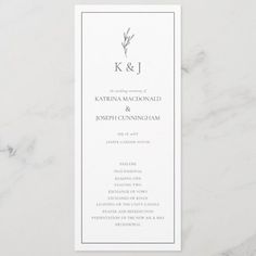 the simple wedding program card is shown on a marble surface with a white envelope and black ink