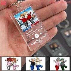 a person holding a clear plastic keychain with cartoon images on the front and back