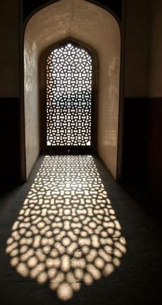 shadows cast on the wall and floor in an archway