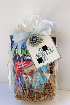 a gift bag filled with candy and other items for someone to put in their basket