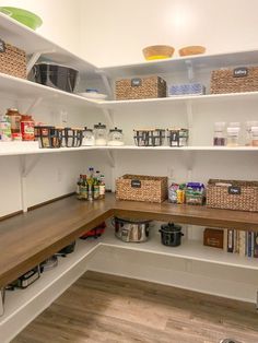 an organized pantry with shelves and baskets