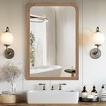 a bathroom sink sitting under a large mirror