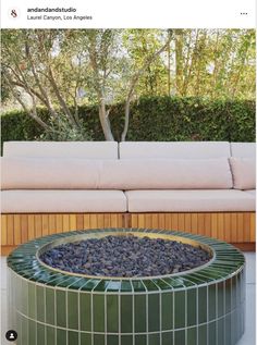 a couch sitting next to a table on top of a patio