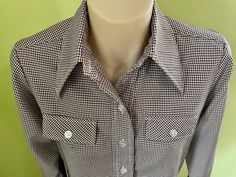 A Women's 1990's vintage western shirt with feminine flair. Brown and white check polyester. Tiny hole under right pocket, not noticeable and priced accordingly.  Please see last pic. Size Medium. Measurements: Chest:  96 cm /  38 inches Shoulder:  38 cm / 15 inches Length:  70 cm /  27 inches Sleeve:  59 cm /  23 inches This item is one of a kind. BUYING VINTAGE: While all care is taken to state any obvious faults, please note that when you buy a vintage or preloved item, they may show small signs of ageing, wear and/or repair. Visit my new website   https://phoenixmenswear.com.au/ Lots of fun stuff for guys and girls...!! Please note that if you are ordering from anywhere outside of Australia please add your phone number as it is now required for delivery.  Thanks much. Vintage Western Shirt, Western Vintage, Western Cowgirls, Western Cowgirl, Western Shirt, Vintage Western, Western Shirts, Guys And Girls, Vintage Brown