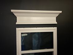 a white window frame against a black wall