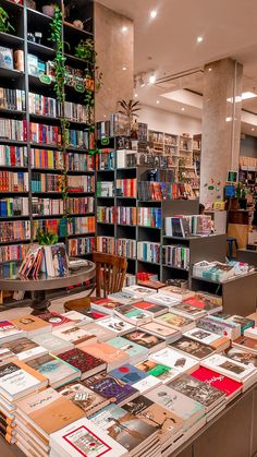 there are many books on the table in this room and one is full of them