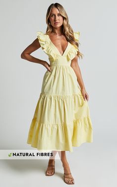 Get ready to turn heads in the stunning Levona Midi Dress. This vibrant yellow A-line dress features ruffle shoulder details and a tiered design, making it perfect for both casual outings and parties. Crafted from soft cotton fabric, this midi dress is as comfortable as it is stylish. The V-neckline adds a touch of femininity, while the short sleeves offer just the right amount of coverage. Whether you're heading out for brunch with friends or hitting the dance floor at night, this lemon-colored Yellow Ruffle Hem Maxi Dress For Spring, Yellow Ruffle Dress With Ruffle Hem For Spring, Yellow Ruffle Hem Dress For Summer, Yellow Ruffle Dress With Ruffle Hem For Summer, Chic Yellow Tiered Maxi Dress, Chic Yellow Maxi Dress With Ruffle Hem, Spring Yellow Dresses With Ruffled Skirt, Yellow Ruffled Dress For Brunch, Yellow Dress With Ruffled Straps And Details