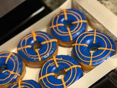 blue and yellow glazed donuts in a box